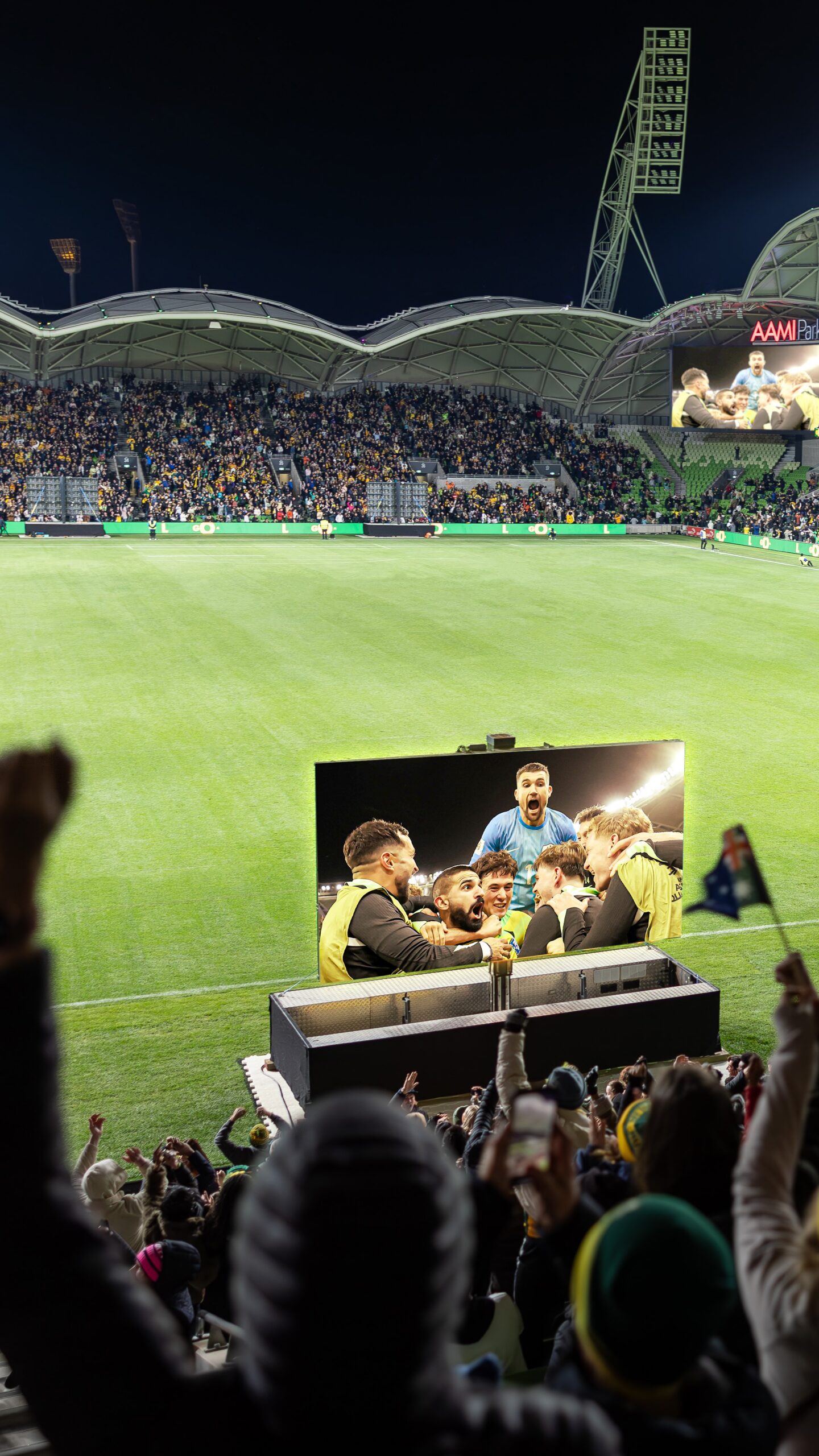 Packed crowd enjoying a football live site in a stadium.